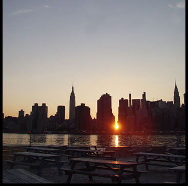 Manhattanhenge sunset over the East River from Water Taxi Beach